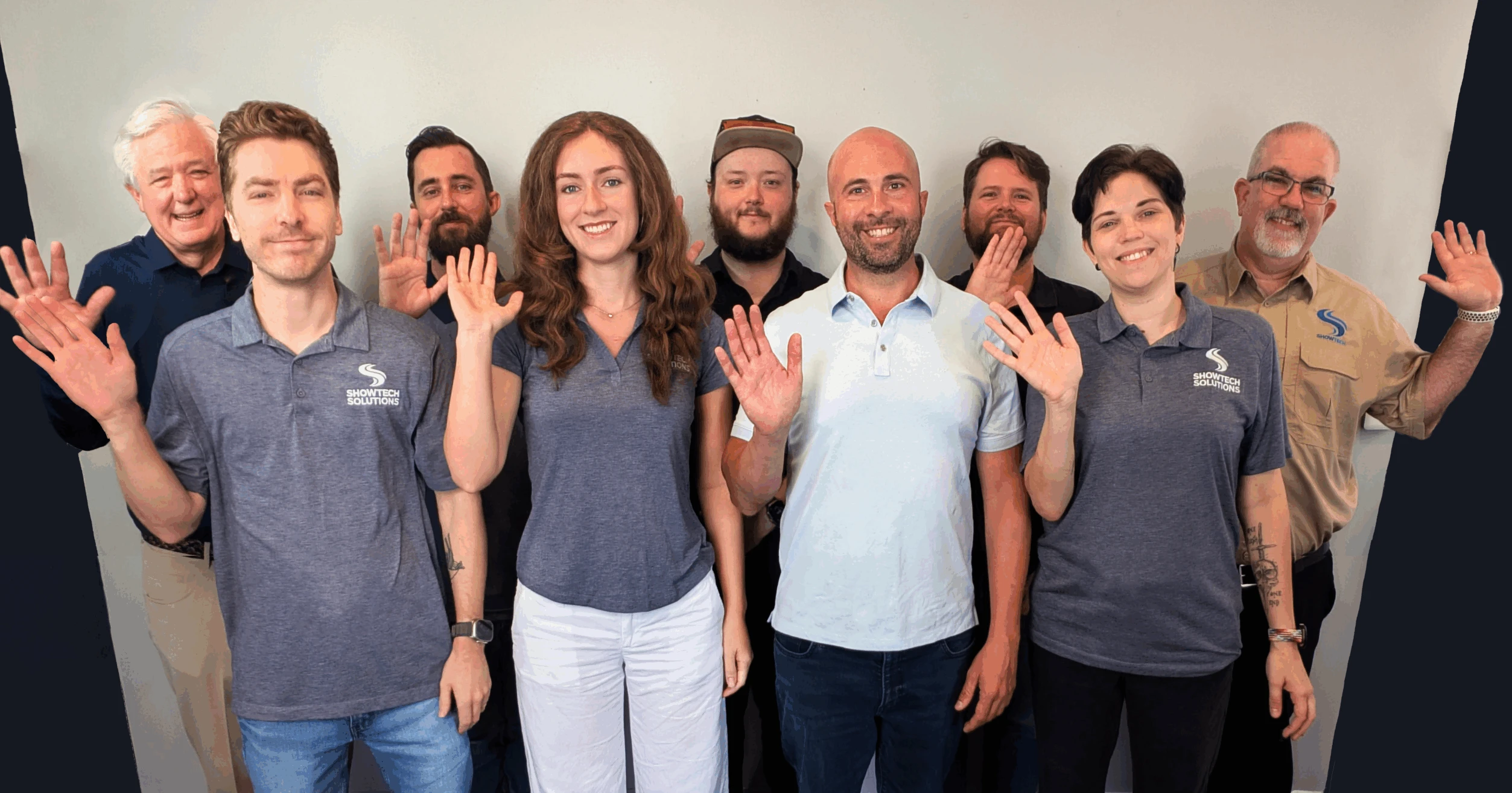 Group photo of the employees of ShowTech. Everyone is waving